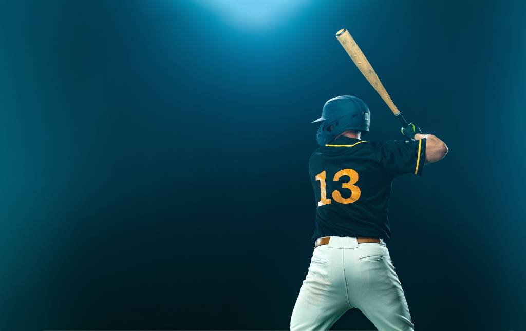 A baseball player up to bat, waiting for the pitch.