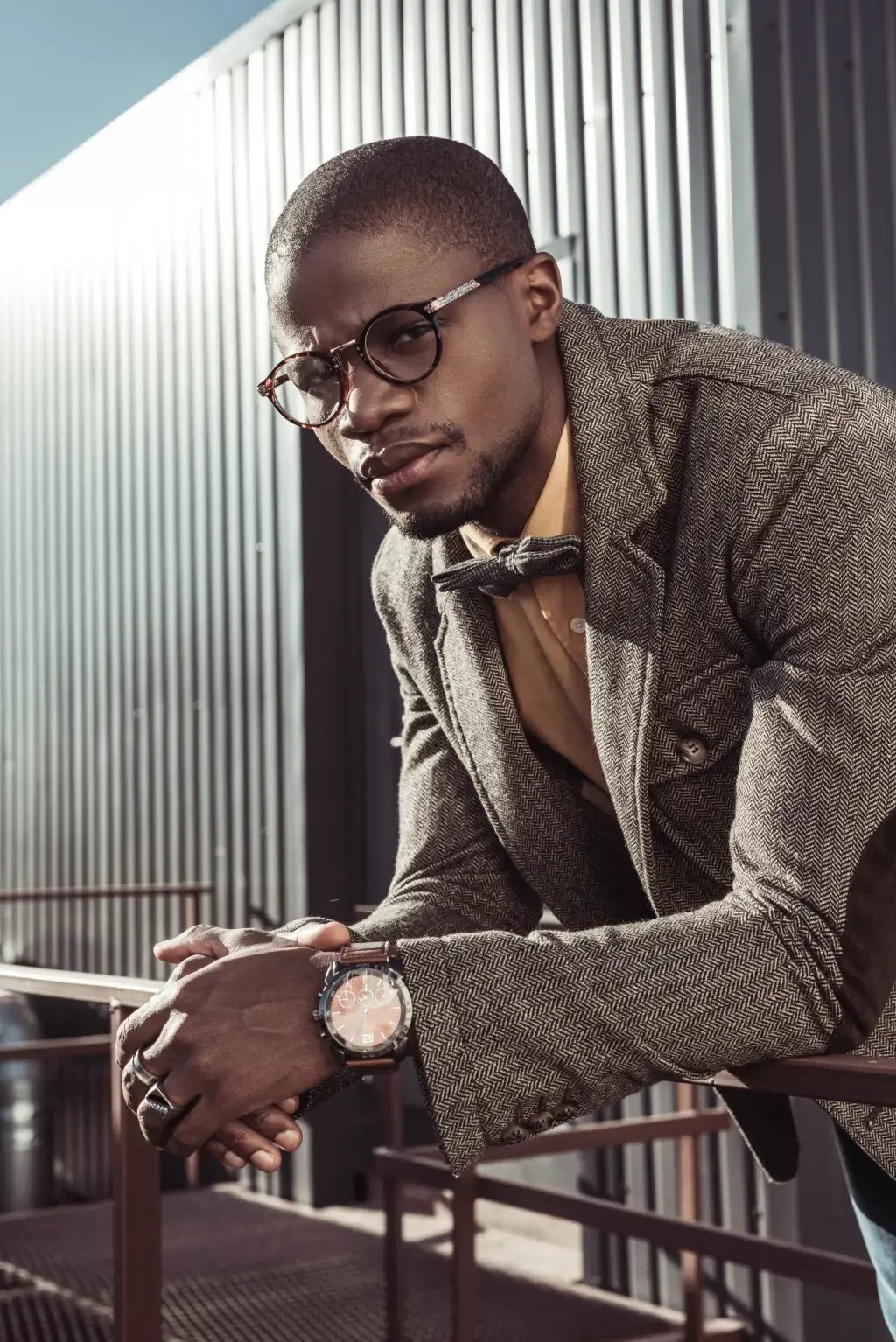 A stylish man in a suit wearing a nice watch.