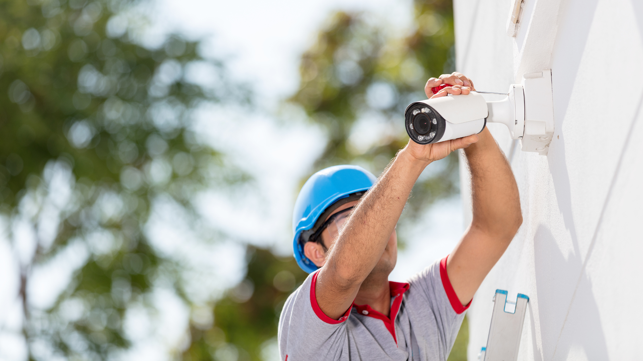 Man setting up security camera