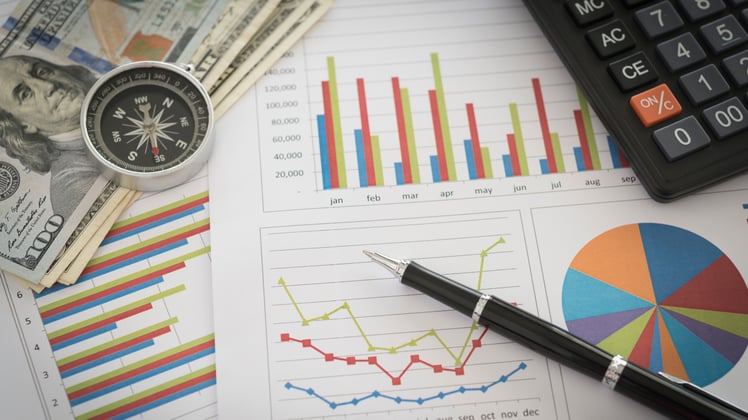Charts and money on a desk