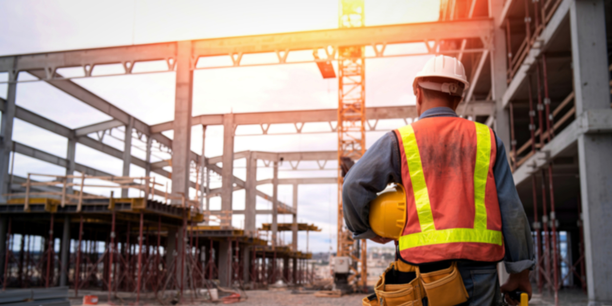 Construction Worker Walking Through Site