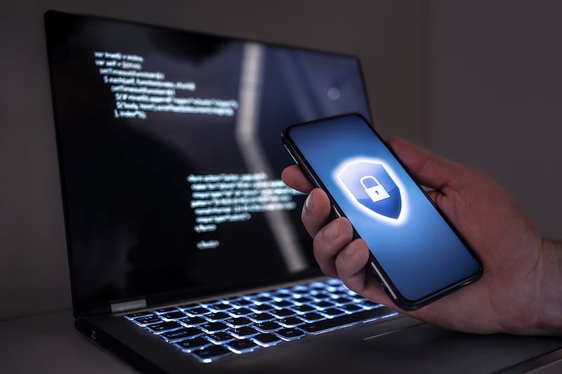 Cybersecurity on phone and laptop