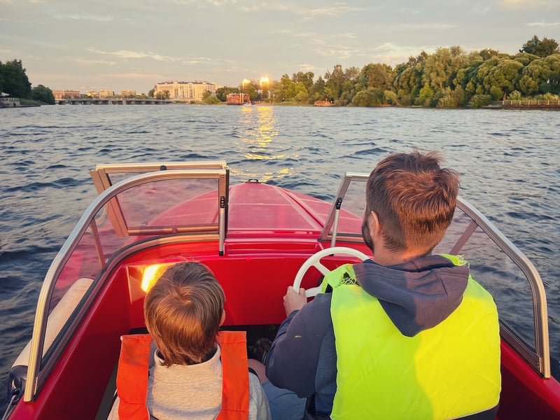 Father and son riding a motor boat