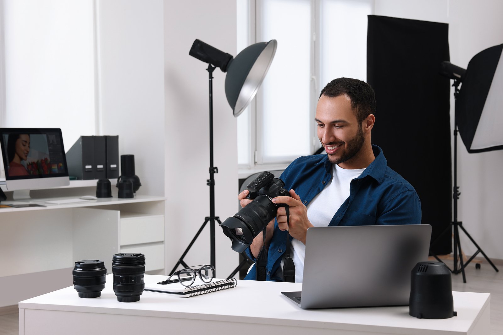 photographer in a photo studio looking at his camera.