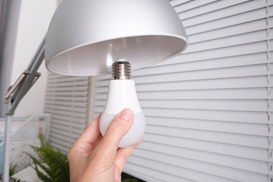 Person replacing lightbulb