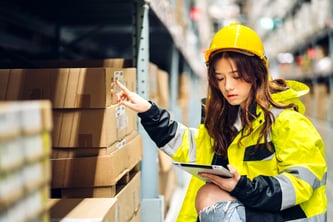 Woman taking warehouse inventory