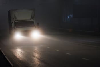 Truck driving on foggy night