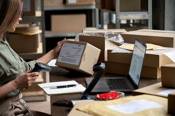 woman scanning items to ship