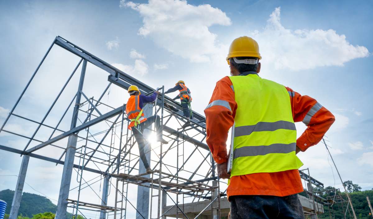 Construction workers building steel frame