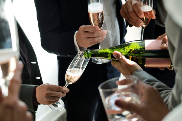 group of people being poured champagne 