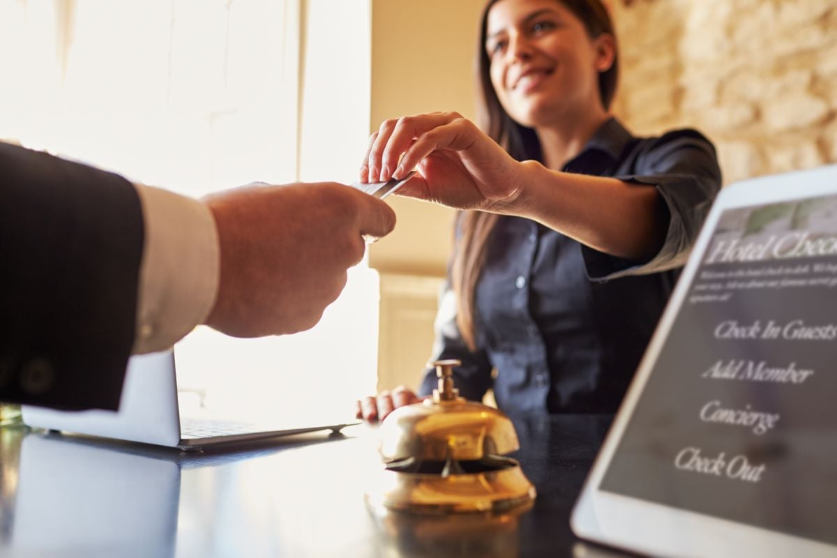 Person checking into hotel at the reception desk