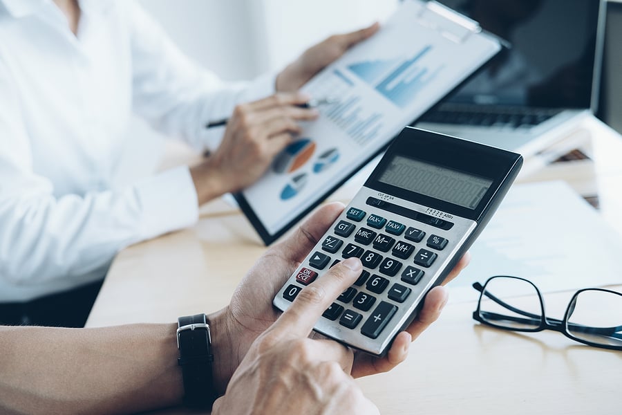Business owners calculating insurance costs