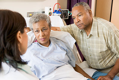 A patient and a loved one speaking with a doctor