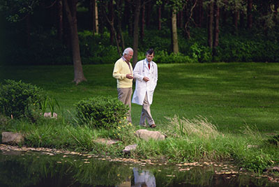 doctor walking with paitent in a park